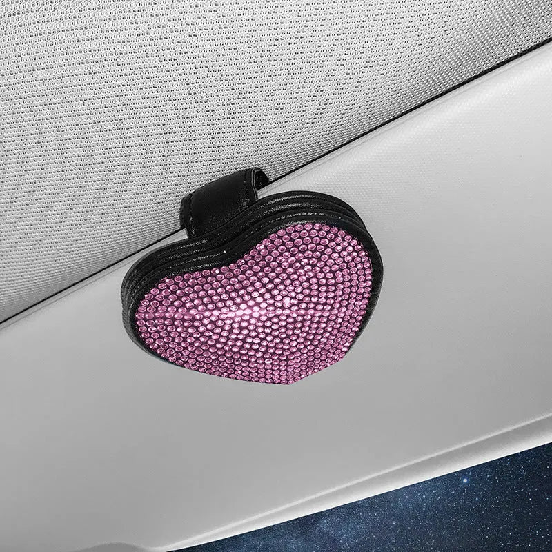A black PU leather magnetic storage clip with a diamond pattern on a car sun visor, holding a pair of sunglasses.