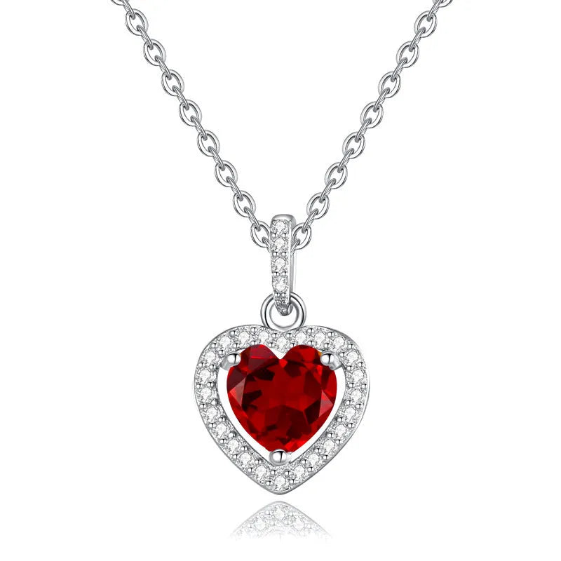 Women's sterling silver necklace with heart-shaped gemstone pendant on adjustable cross chain
