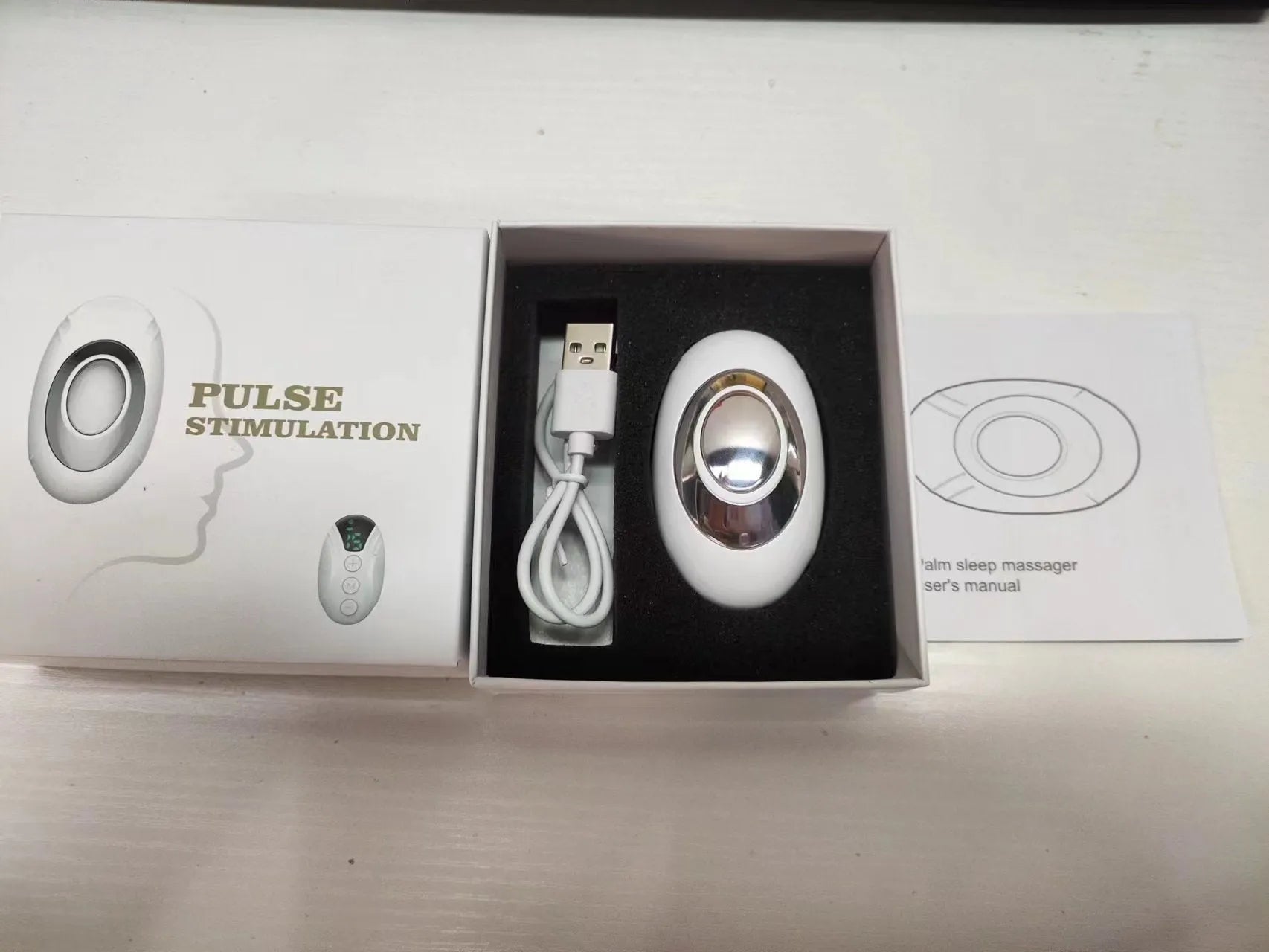 Intelligent charging hand-held pulse decompression insomnia help device in white with wireless remote control and USB cable