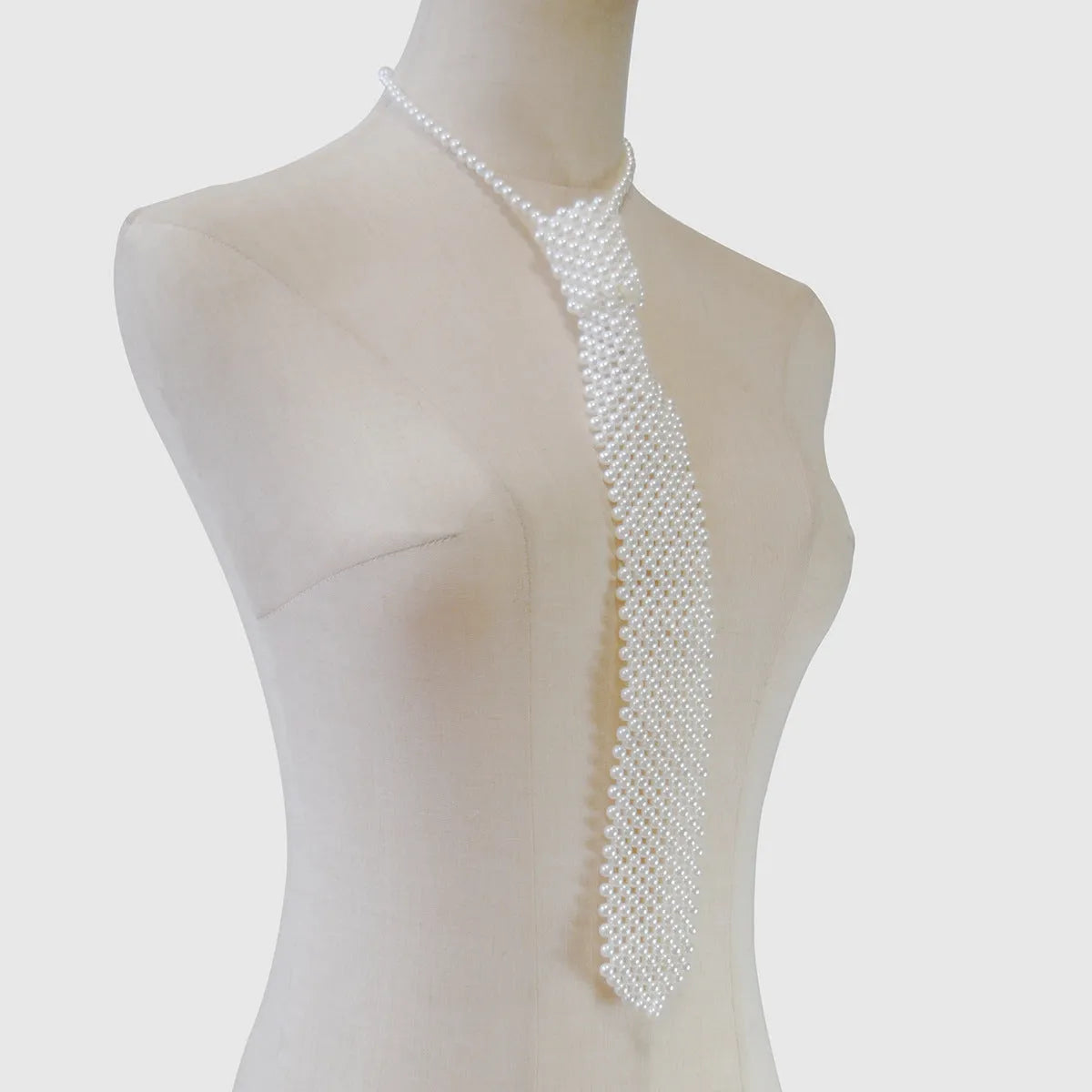 Women's pearl tie body chain with hollow out design and adjustable alloy closure in black or white colour