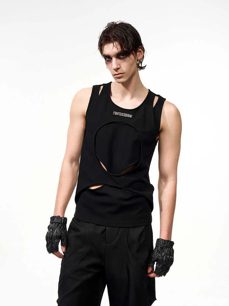 Man wearing a white, sleeveless, hollow-knit cotton waistcoat with a round neck.