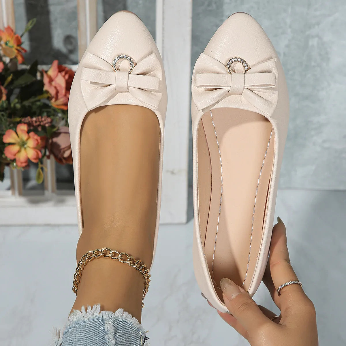 Women's beige casual flat shoes with a bowknot detail on the artificial PU upper.
