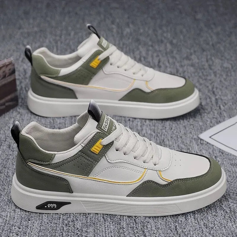 Men's low-top canvas shoes in grey with leather stitching detail on a white background