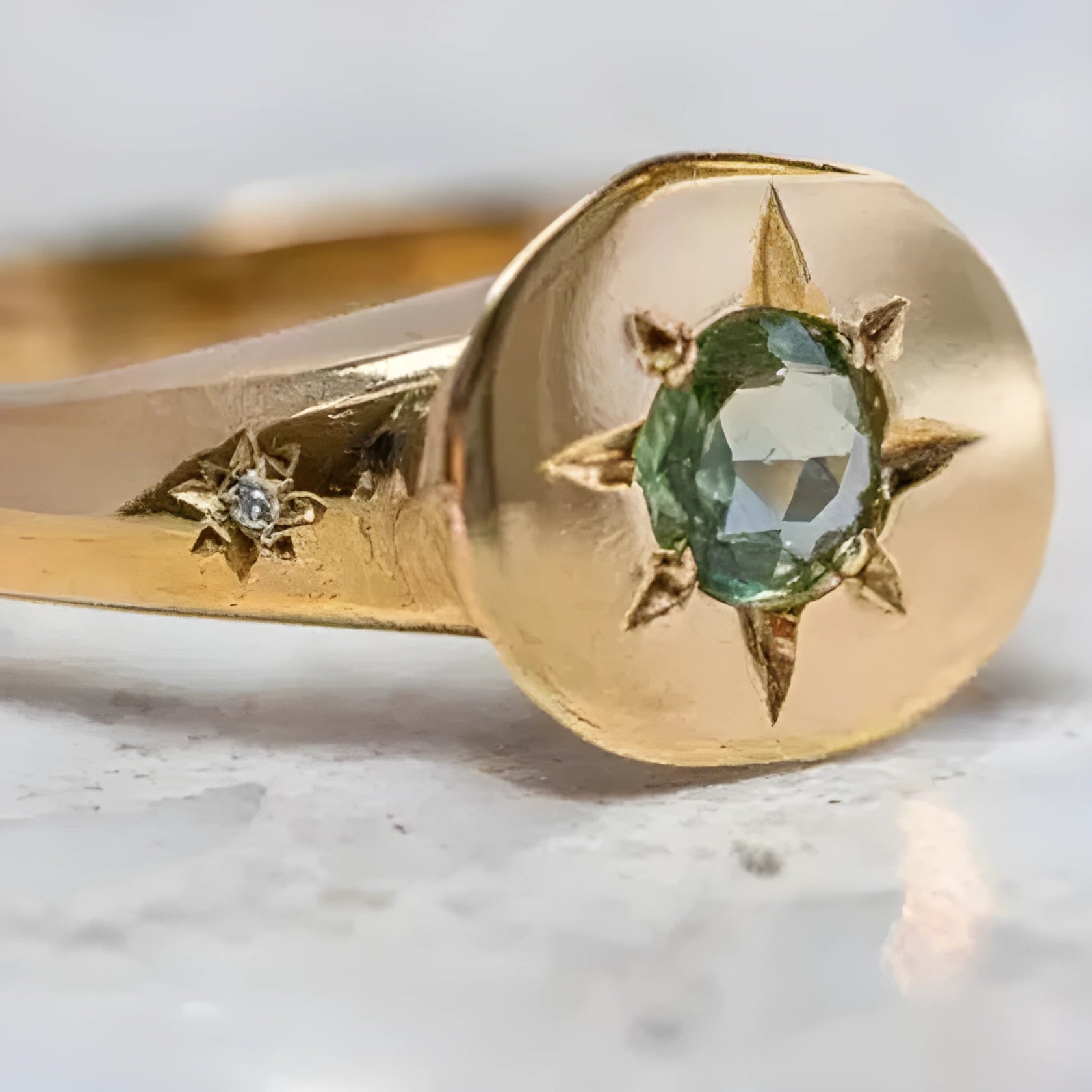 Gold coloured adjustable ring with oval star shape and central asterism zircon stone.