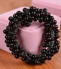 Cloth beaded hair rope in black colour on a white background