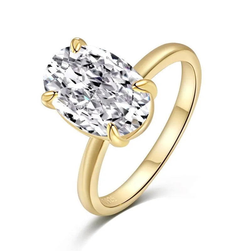 Oval gemstone ring in silver with four-claw setting on a model's hand.