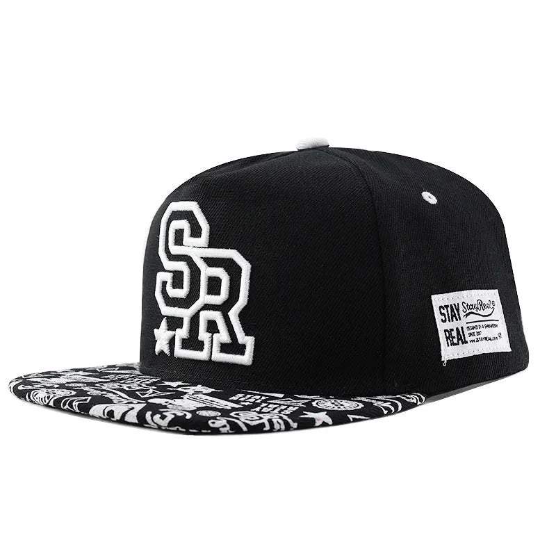 Black cotton baseball cap with white embroidered lettering on the front, showing adjustable back strap.