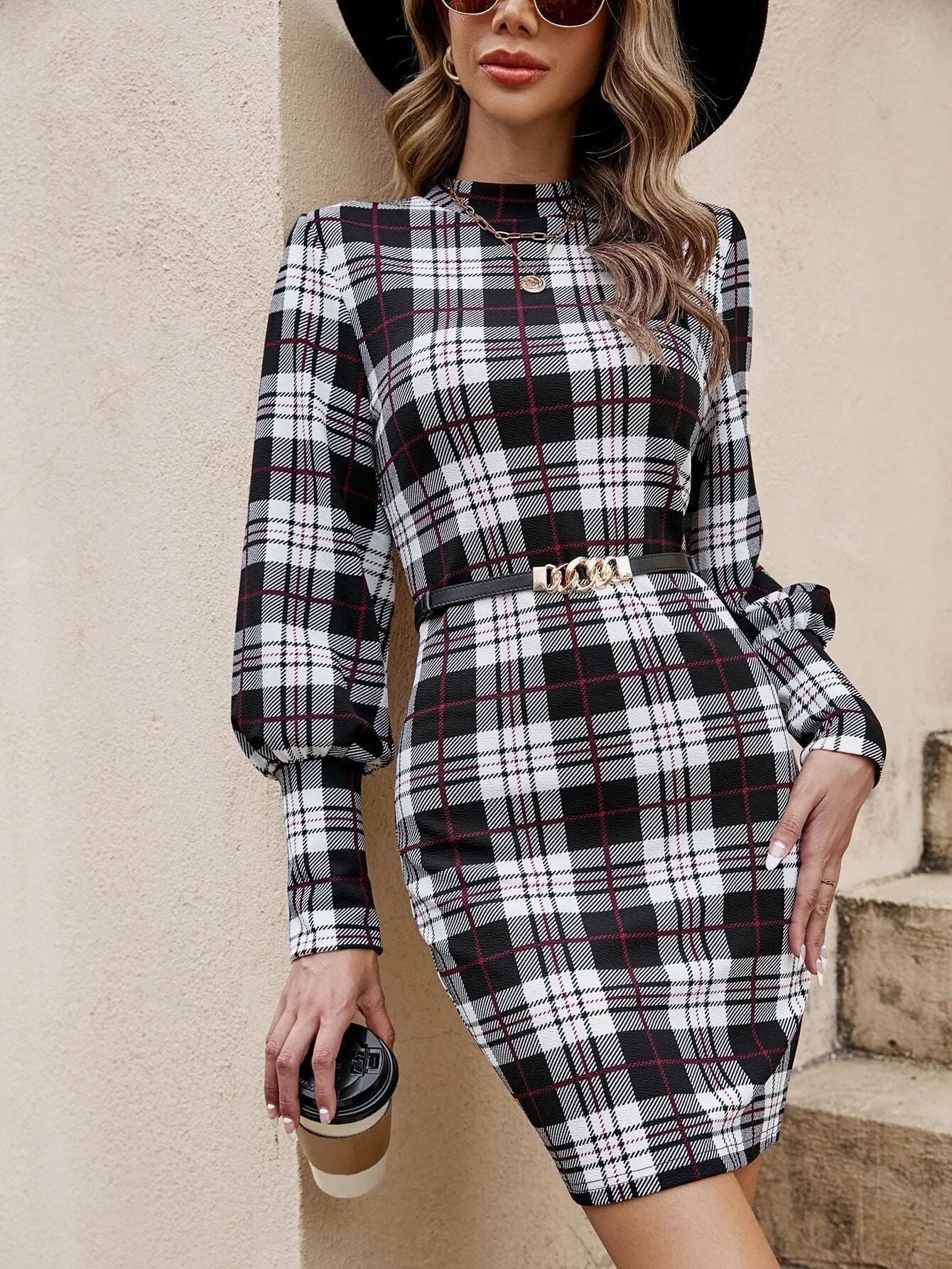 Black printed tight dress with lantern sleeves and leather stitching detail.
