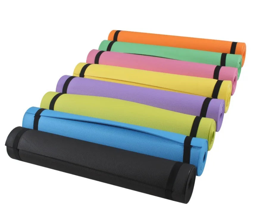Red EVA yoga mat showing thickness, next to a blue mat, on a wooden floor.