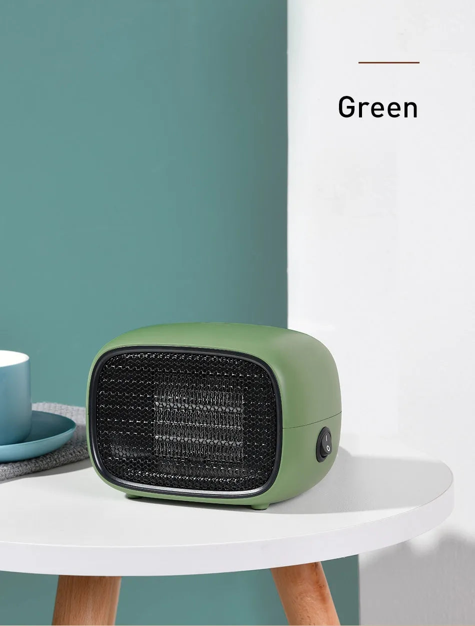 Compact green mini ceramic desk heater with metal grille, shown with dimensions.