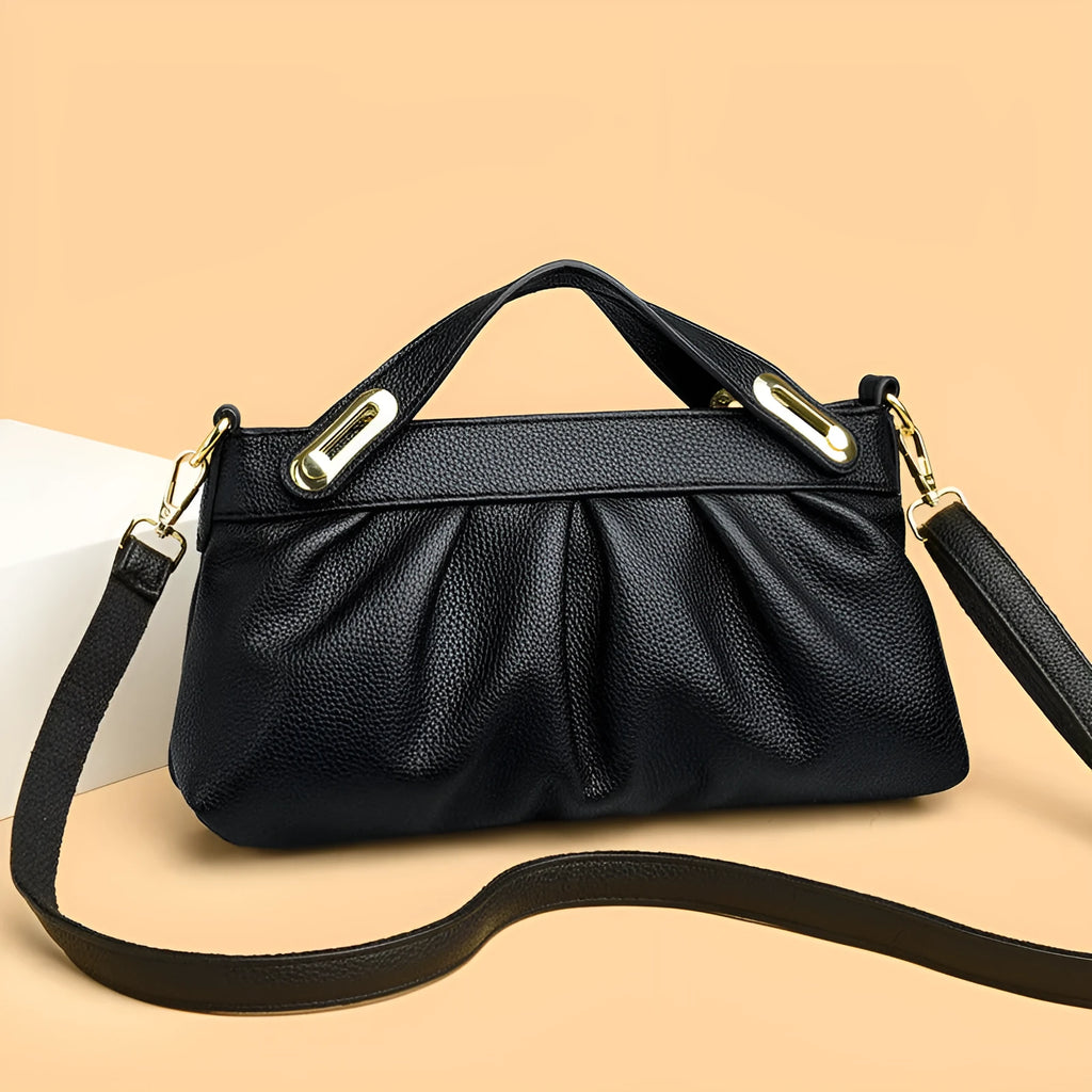 Genuine leather crossbody bag with pleated shoulder strap and wrinkled composite leather finish in horizontal square shape