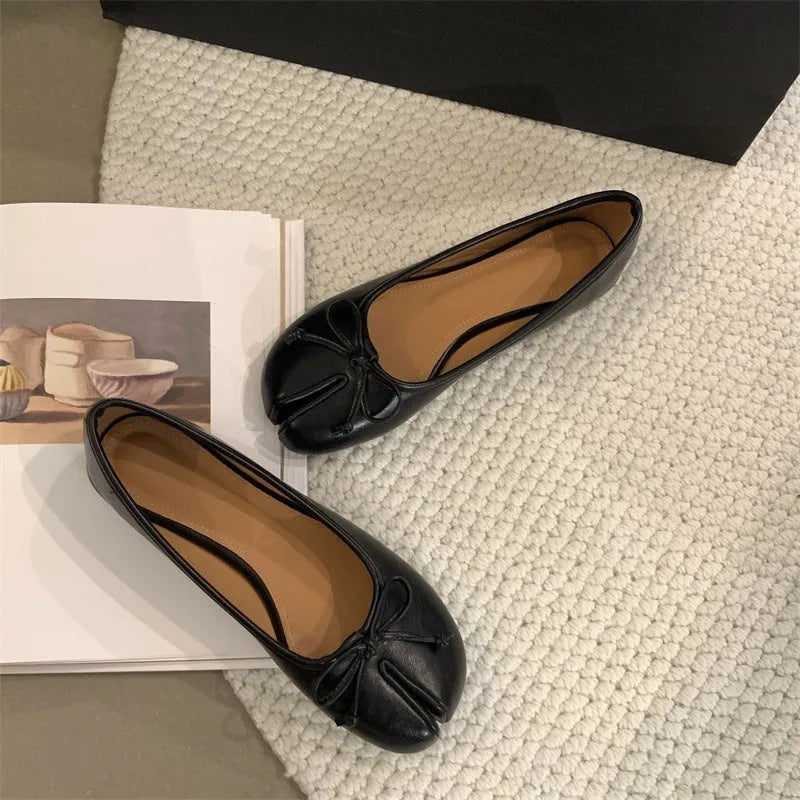 Women's flat split-toe pumps in beige with round toe and rubber sole.