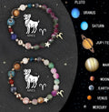 Set of twelve natural stone beaded bracelets on a table, each representing a different zodiac sign with elastic cords.