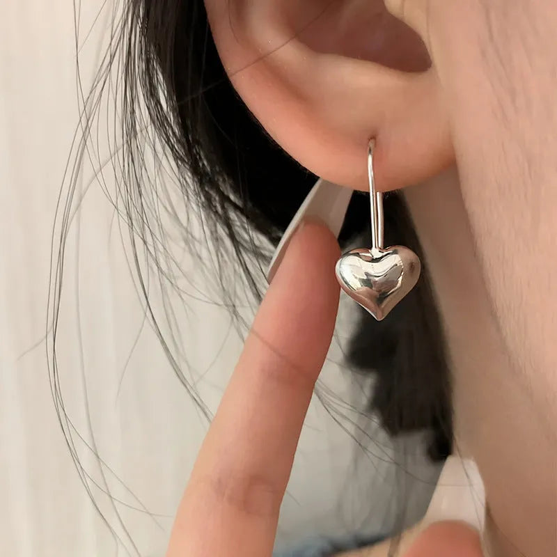 Korean-style glossy silver heart earrings with three-dimensional design and heart-shaped hooks