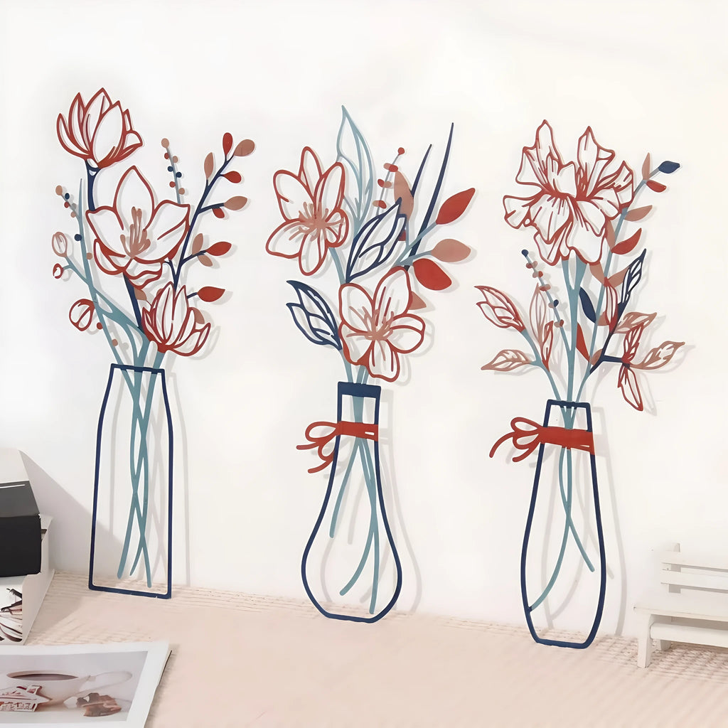 Set of three metal wall decorations with floral and vase designs in a farmhouse style.