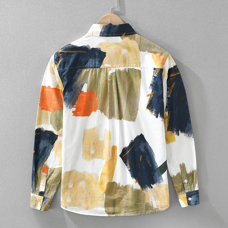 Loose fit cotton cardigan top with long sleeves in a printed colour design, shown on a hanger.