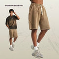 Men's loose fit batik washed cotton terry shorts in a retro street style, shown in a batik grey green colour.