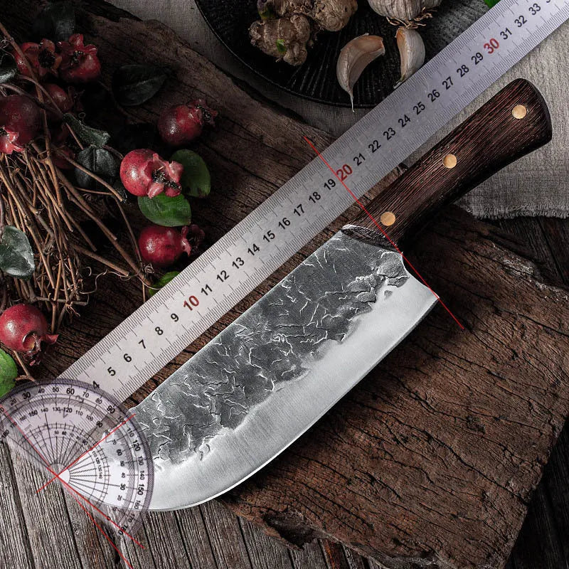 Hand forged stainless steel butcher knife with chicken wing wood handle and copper nails on a cutting board