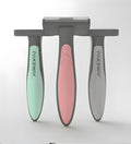 T9 series pet hair removal comb in pink, mint green, and grey on white background