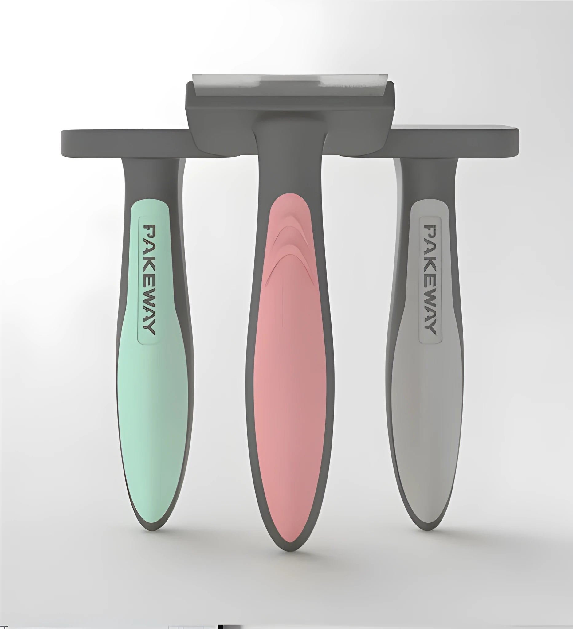 T9 series pet hair removal comb in pink, mint green, and grey on white background