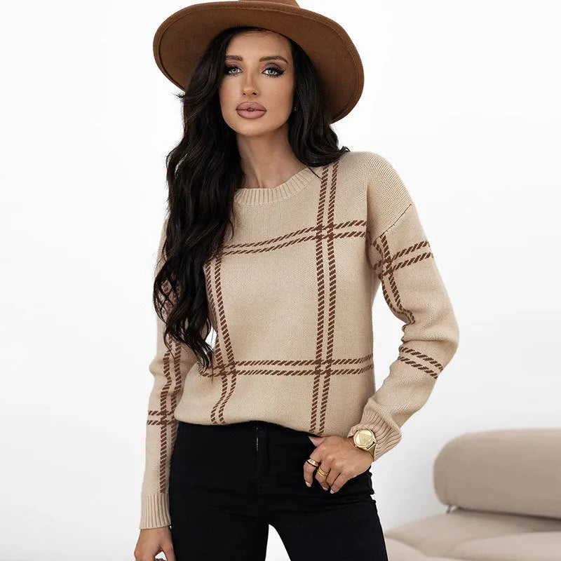 Women's apricot, black, beige, red and green plaid colour-block crew neck acrylic sweater on a hanger