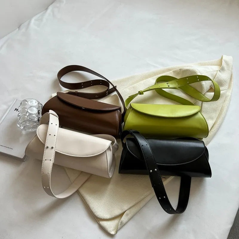 PU leather cylinder crossbody bag in black, horizontal square shape with crossbody strap