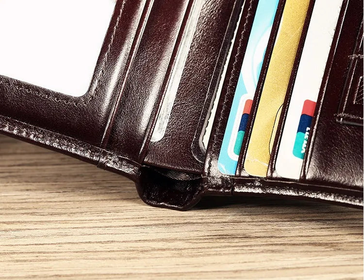 Men's black full-grain leather bifold wallet open, showing card slots, note pocket, and zipped coin compartment.