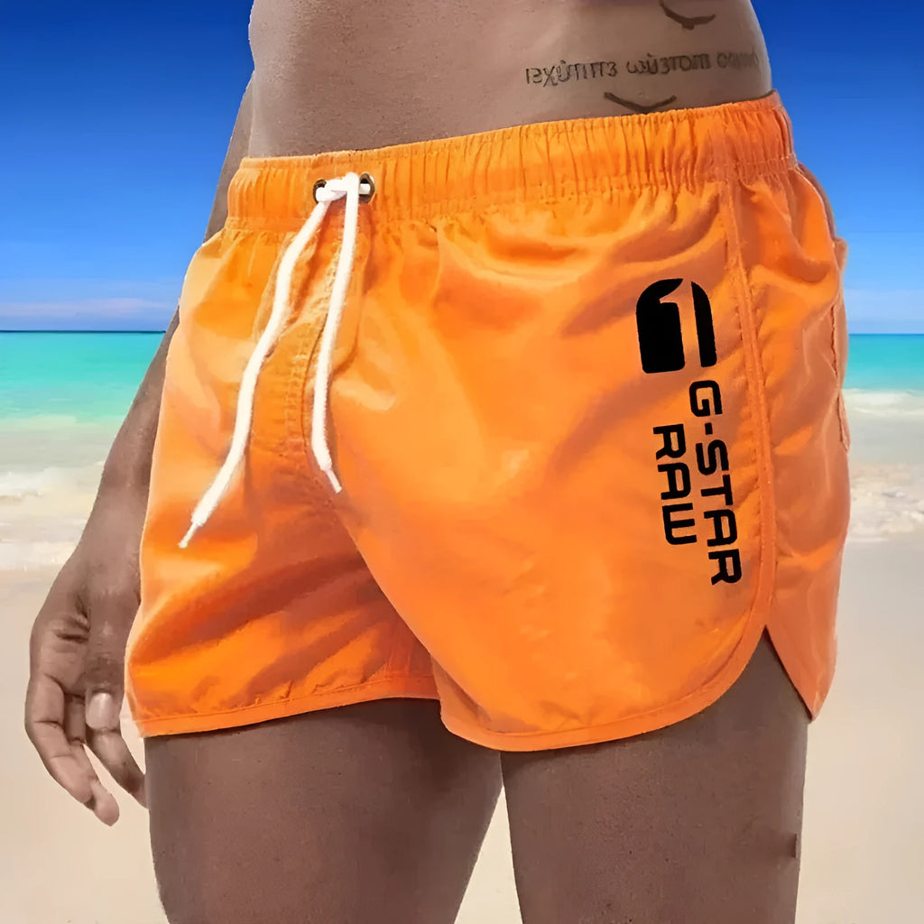 Men's thin polyester sports shorts in various colours with an elasticated waistband.