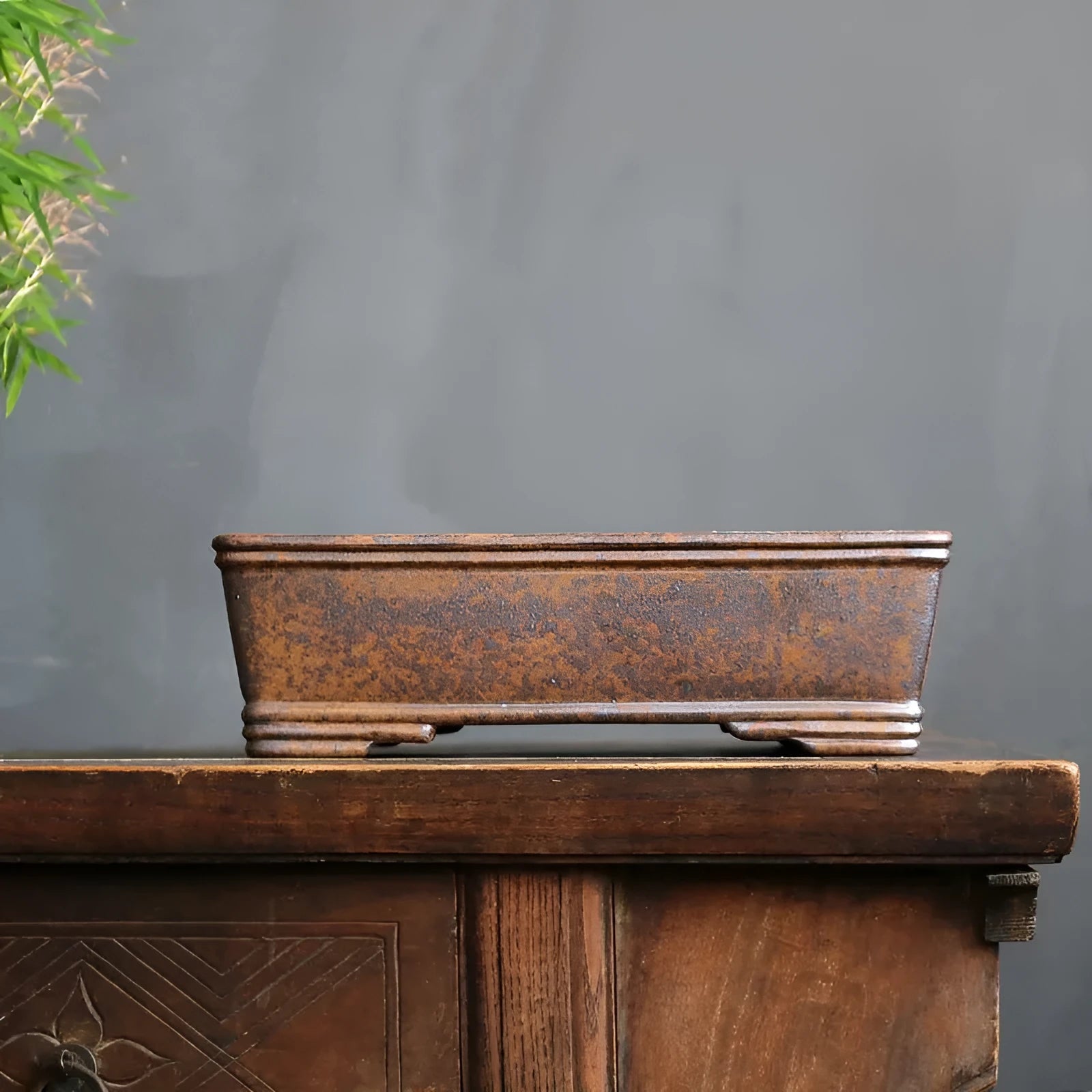 Rectangular purple sand bonsai pot on floor, showing simple five-line basin design.