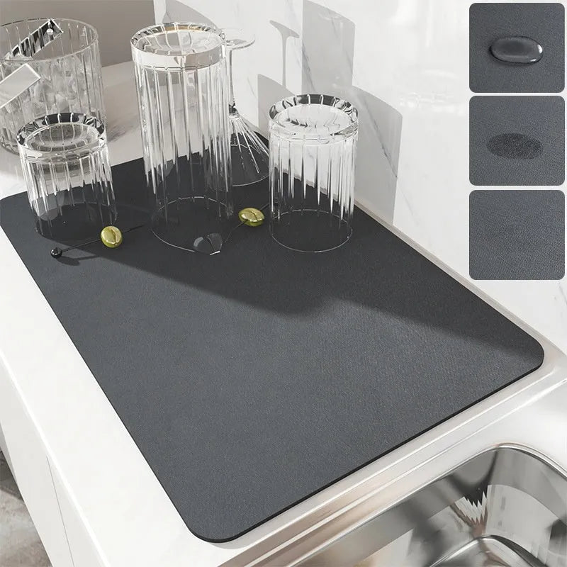 Black super absorbent rubber-backed kitchen drain mat on a countertop