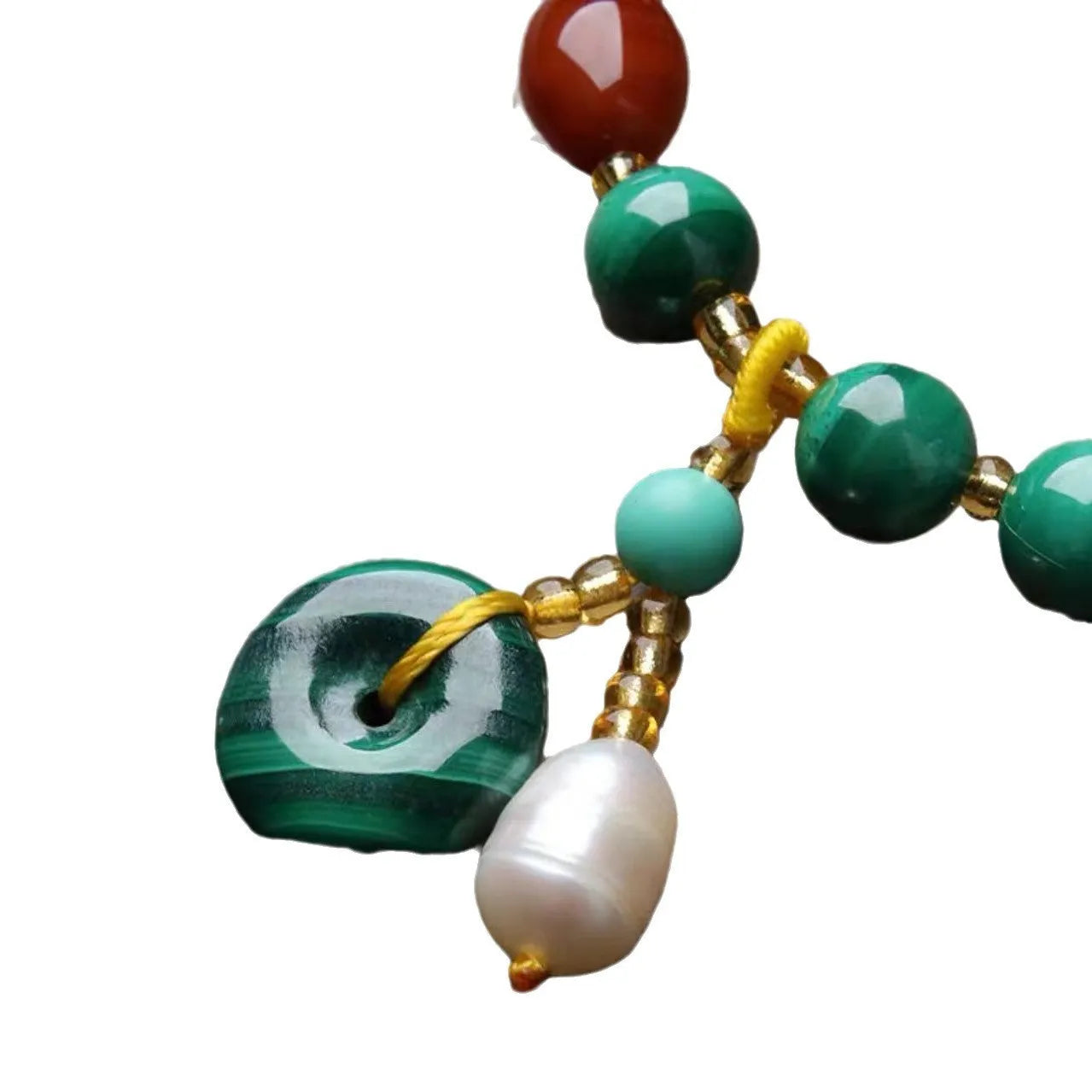 Close-up of a natural malachite and red agate bracelet with 7-8mm barrel beads on a wrist.