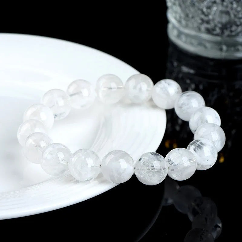 Original design women's crystal bracelet with natural blizzard snowflake round beads on a wrist.