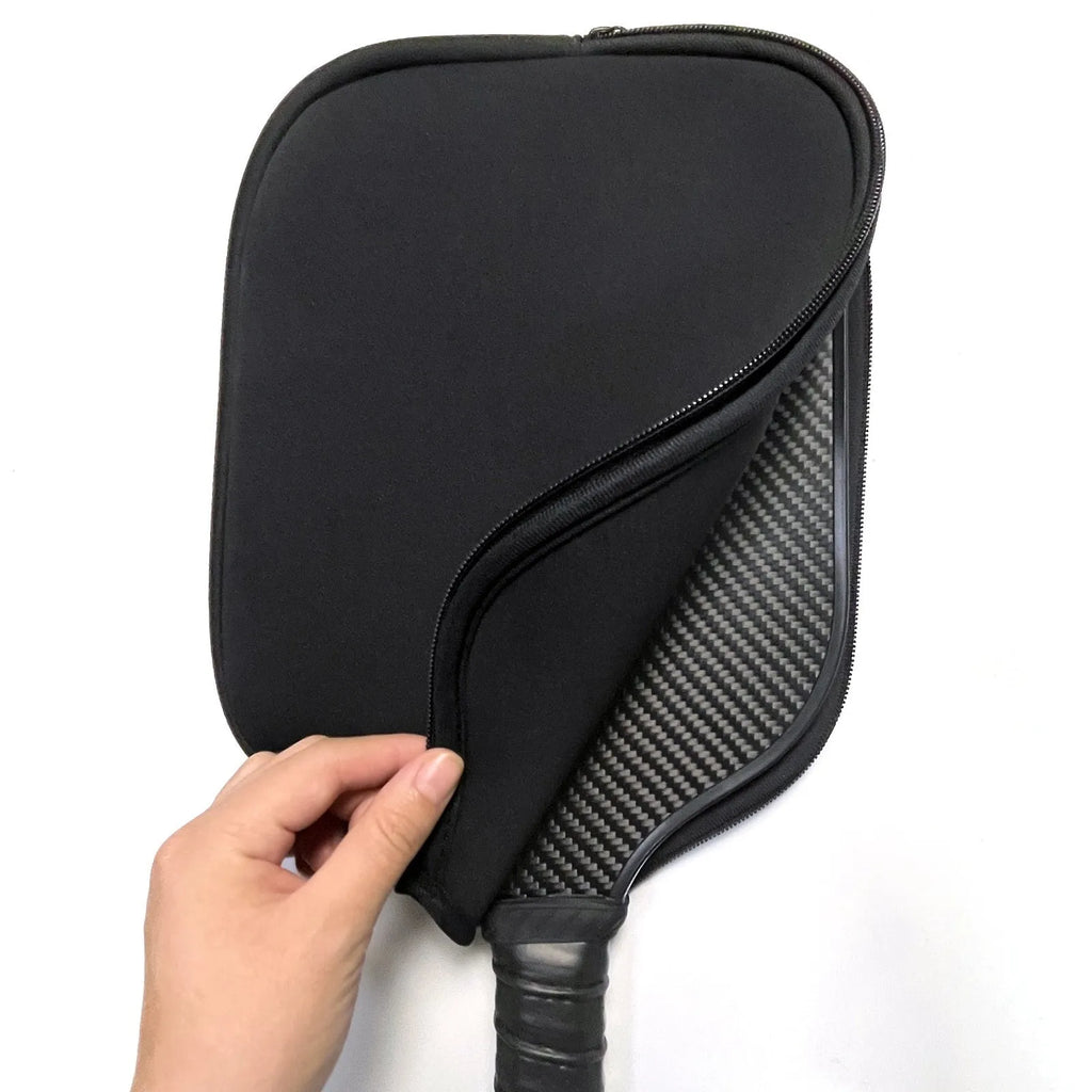 Black neoprene protective sleeve for a table tennis racket on a plain background.