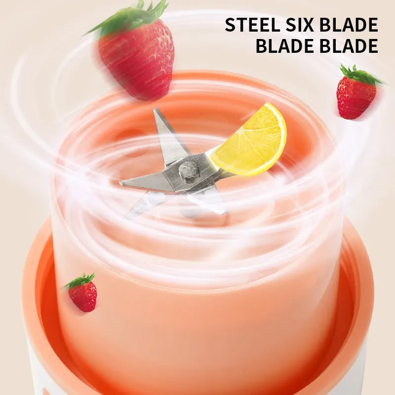 Blue portable electric juicer with USB charging cable next to a cup of blended fruit smoothie.