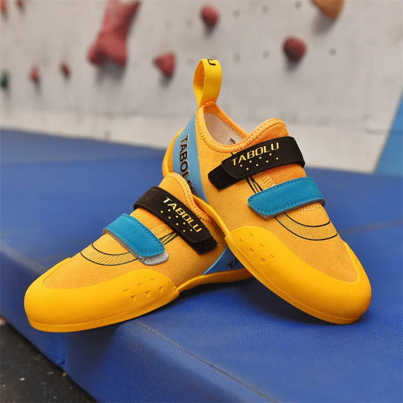 Beginner rock climbing shoes with Velcro strap in black and red colourway.