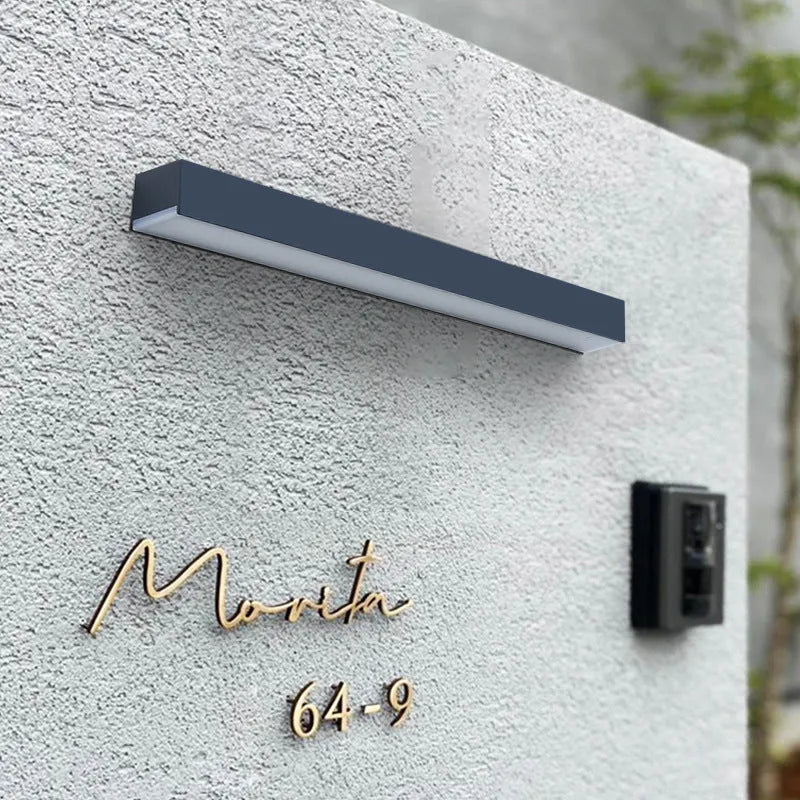 Black solar-powered outdoor wall lamp with integrated solar panel and LED light.