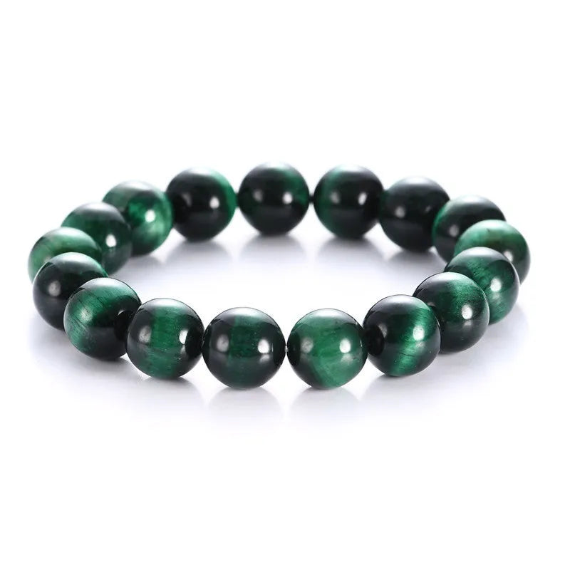 Green Tiger Eye stone bracelet with round polished beads on a wrist.