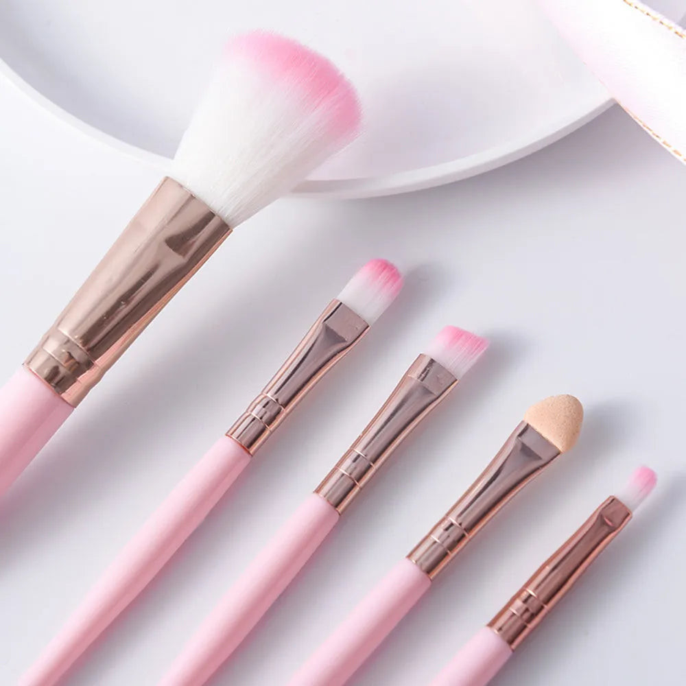 Five mini makeup brushes with short plastic handles, man-made fibre bristles, 8.5cm total length, blue and pink colours