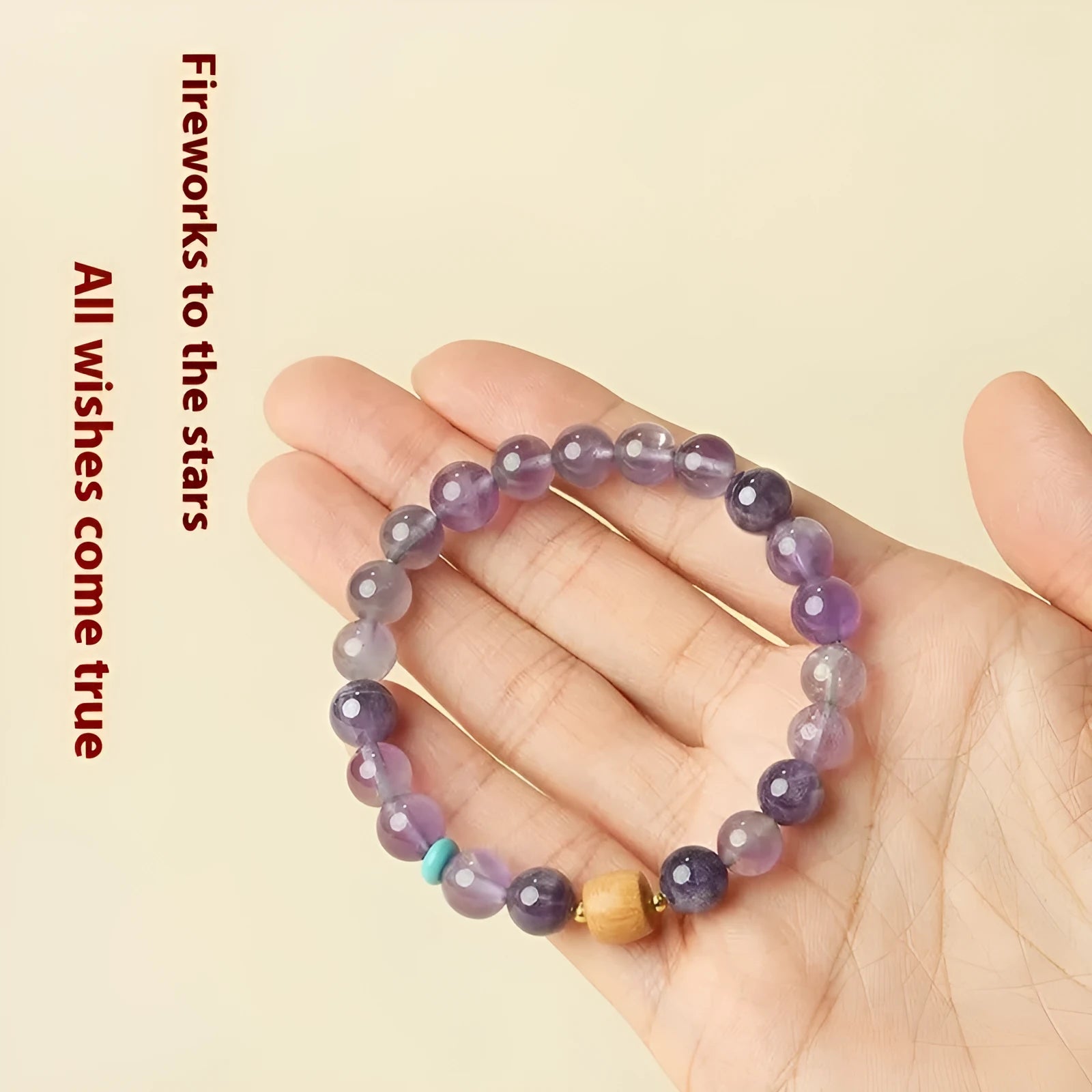 Handmade purple amethyst crystal bracelet for women on a wrist.