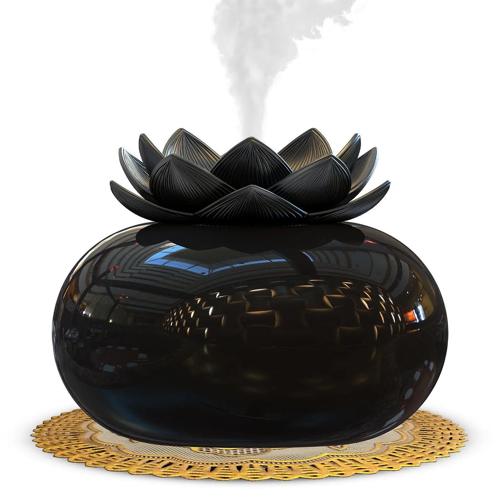 Pure black lotus-shaped aromatherapy humidifier with USB cable on a desk