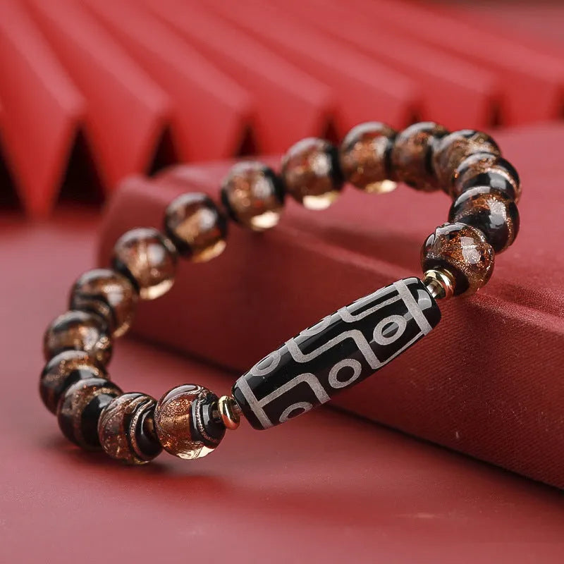 Close-up of a handcrafted coloured glaze bracelet with multi-colour lucky beads and auspicious Chinese patterns.