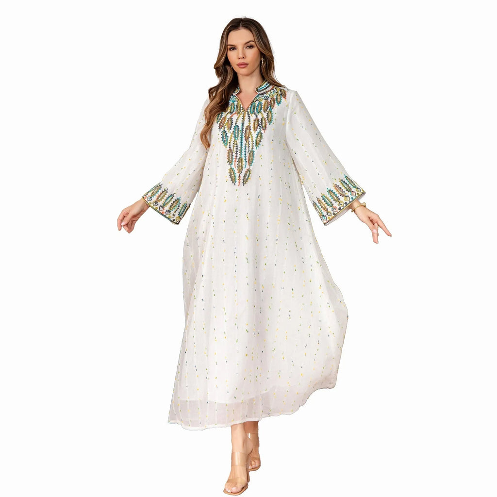 White long sleeve Arabic robe abaya on a hanger, full-length polyester maxi dress.