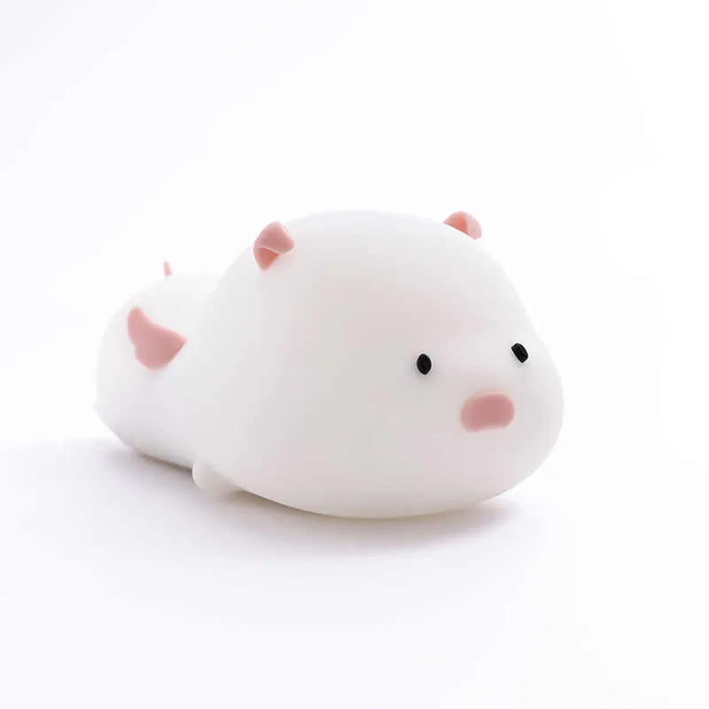 Blue rechargeable silicone night light shaped like a sleeping pig with soft LED glow.