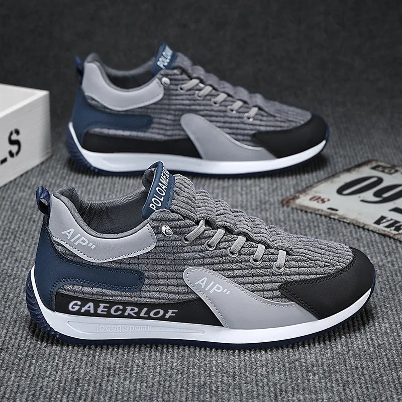 Men's green and grey running shoes with mesh upper and lace-up closure on neutral background