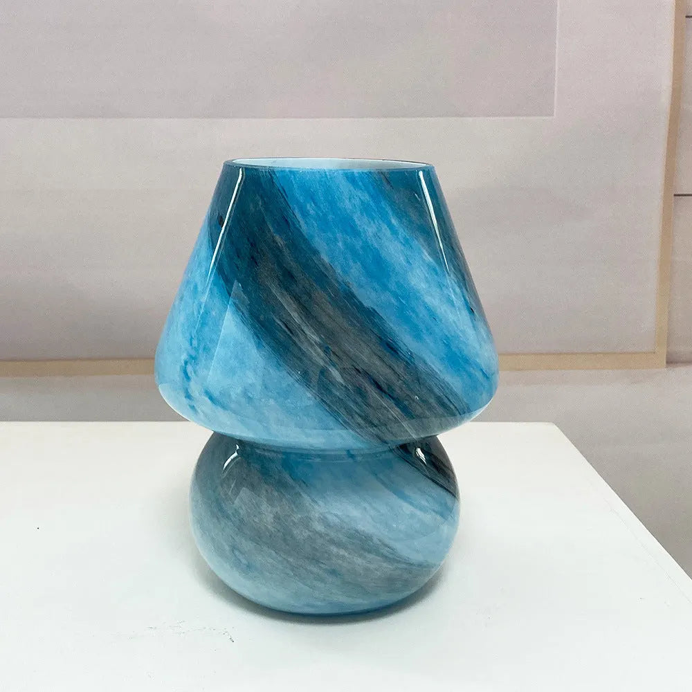 Handmade glass mushroom table lamp in Earth colour finish on a bedside table, showing its compact 15x19cm size
