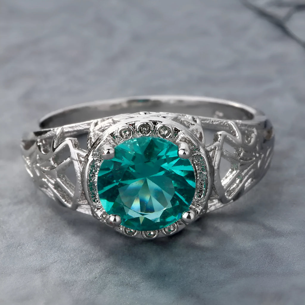 Copper electroplated silver ring with a clear zircon stone inlay on a neutral background