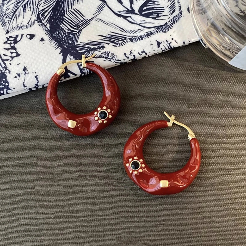 A pair of retro-style alloy ear studs with inlaid rhinestones, shown in black and red colour options.