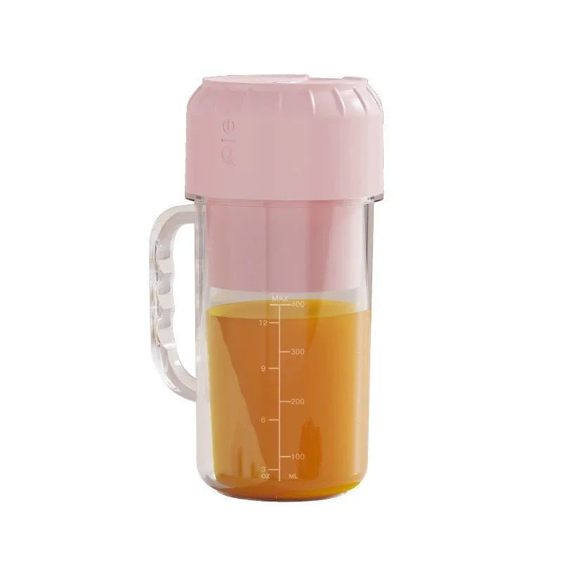 Portable USB charging personal juicer in cherry blossom pink or avocado green colour on a table.