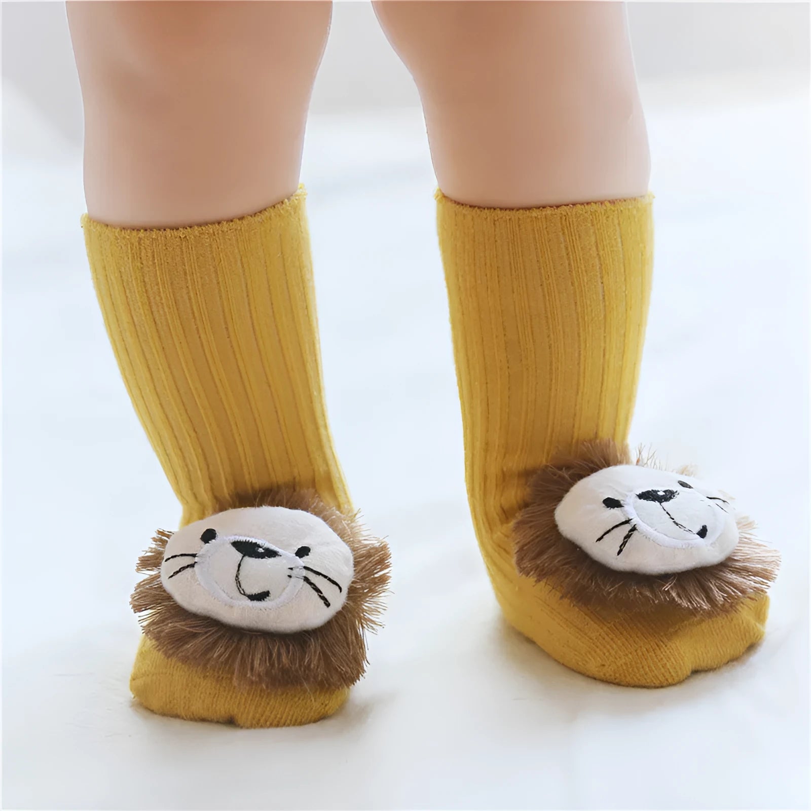 Cotton baby floor socks in various colours and patterns including pink bows, grey stars, and panda design.