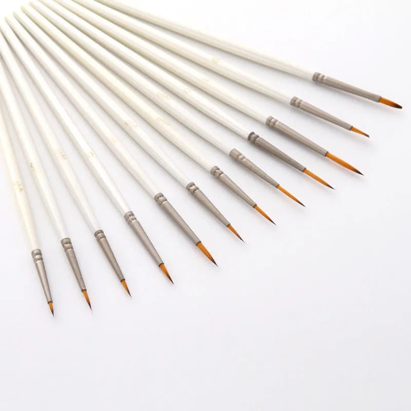 Set of 12 pearl white artists' brushes in a solid wood holder, sizes from 0 to 4/0 for watercolour and acrylic painting.